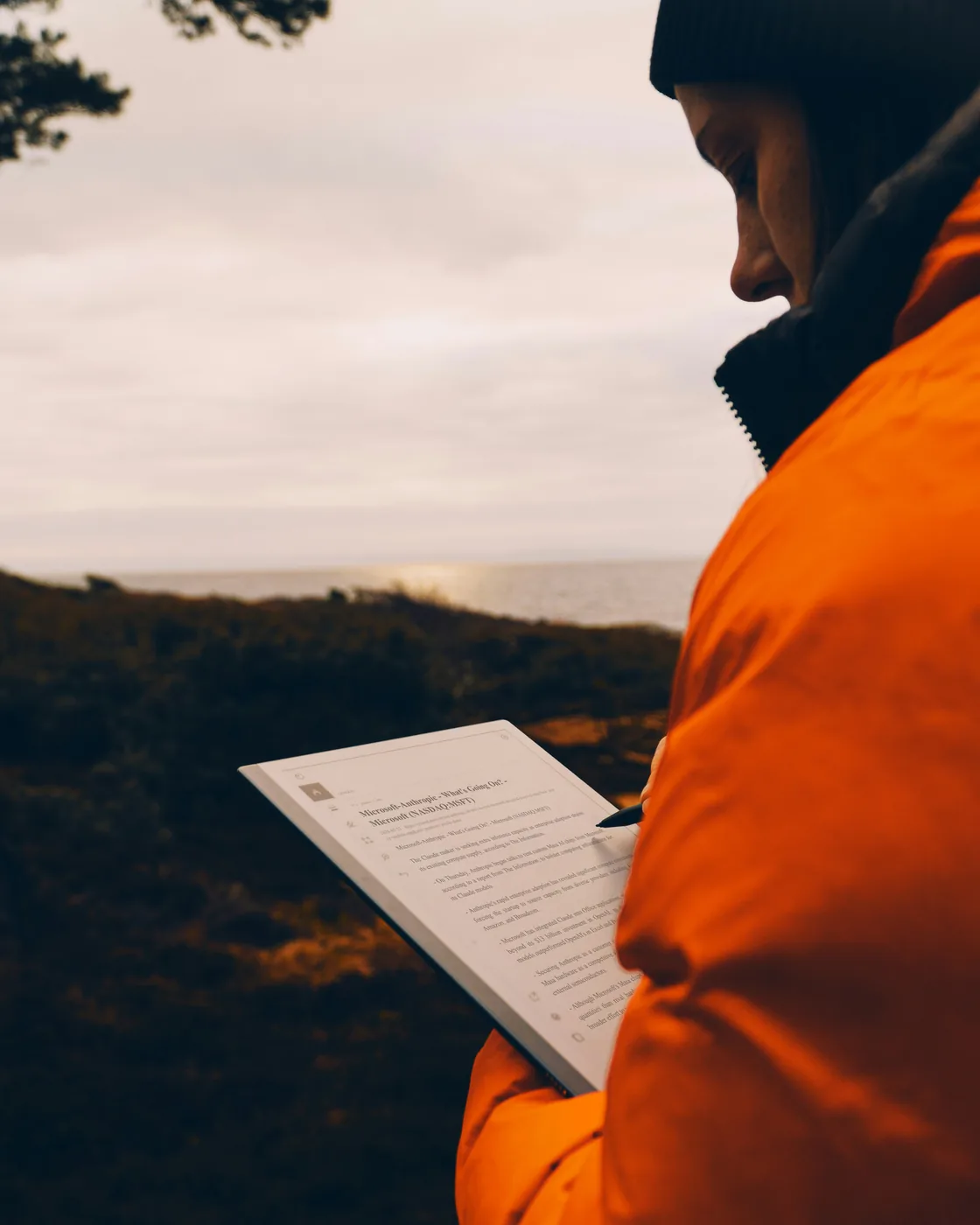 Person reading on an e-reader outdoors